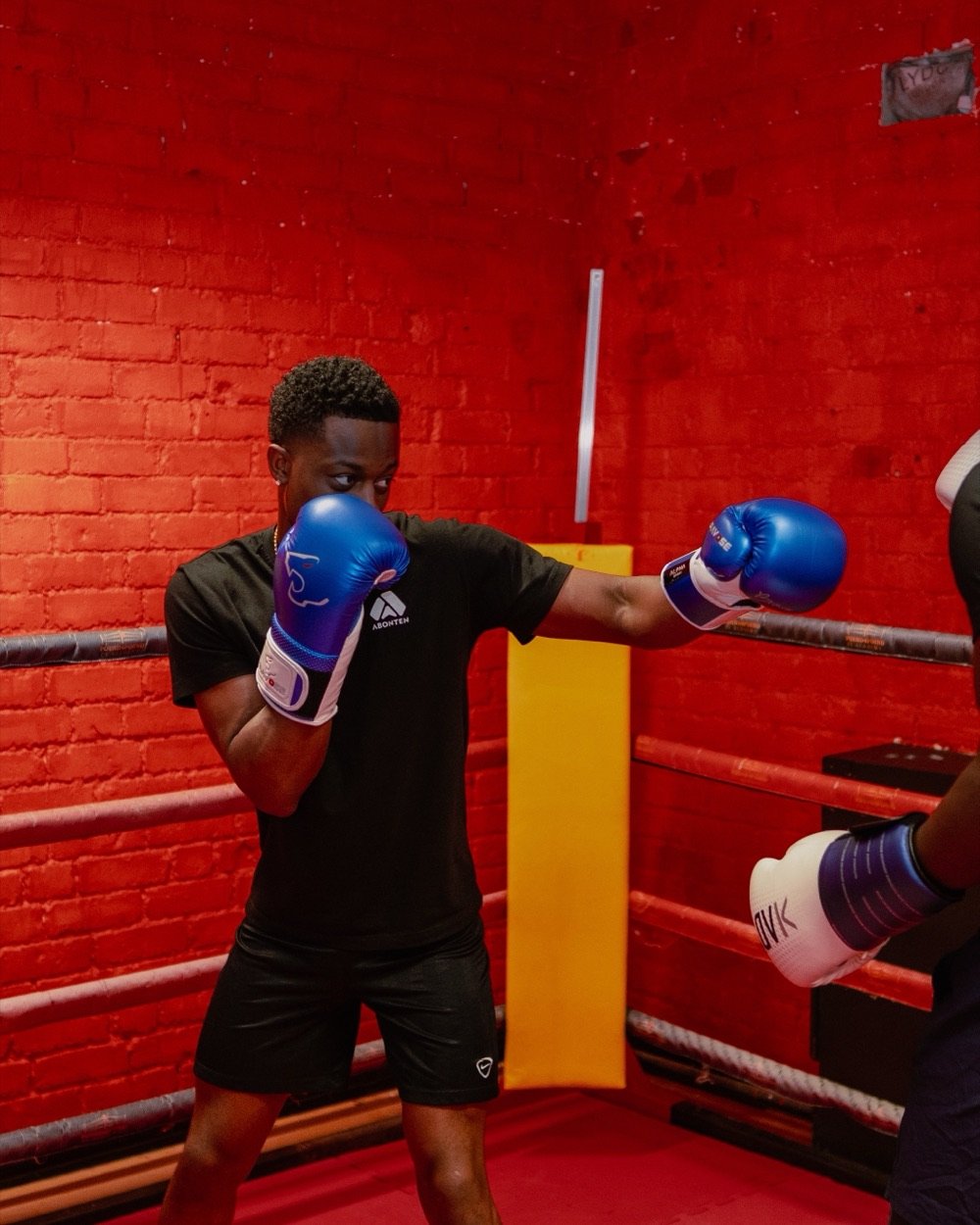 A member throwing a jab during pad work in the ring
